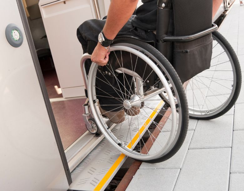 About Accessibility: Person in a wheel chair entering a transport